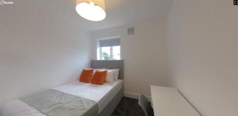 A bright and inviting double bedroom with clean...