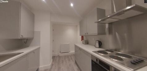 A modern and tidy kitchenette equipped with ess...
