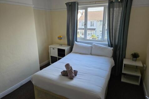A bright and inviting double bedroom with ample...