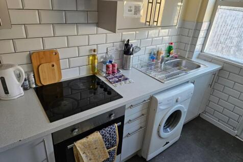 A bright and modern kitchenette featuring ample...