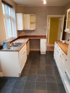 A spacious kitchen with ample storage and natur...