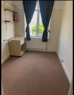A bright and tidy double bedroom featuring larg...