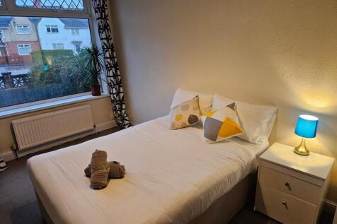 A bright and inviting double bedroom featuring ...