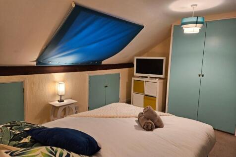 A stylish and inviting double bedroom featuring...