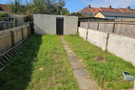 A spacious garden with a well-defined pathway, ...