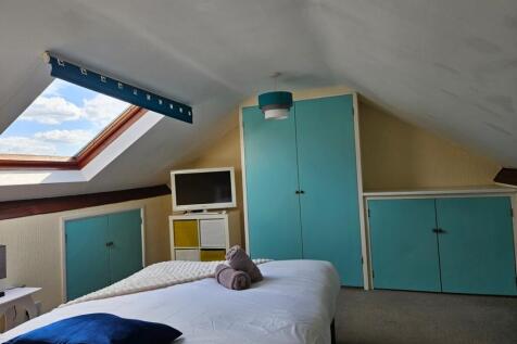 A bright and inviting double bedroom with ample...