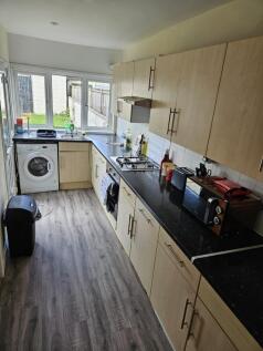 A bright and functional kitchen with ample stor...