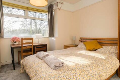 A bright and inviting double bedroom with ample...