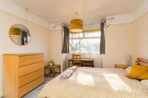 A bright and inviting double bedroom featuring ...