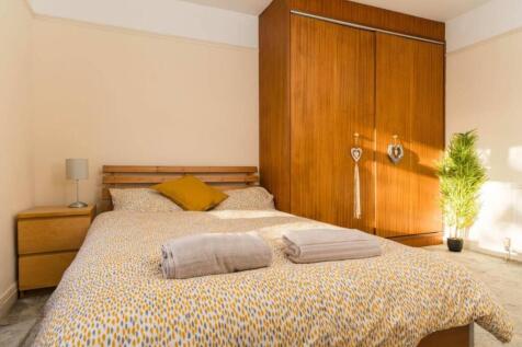 A bright and inviting double bedroom featuring ...