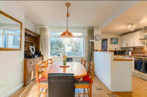 A spacious and bright kitchen area featuring a ...