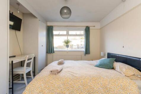 A bright and inviting double bedroom featuring ...