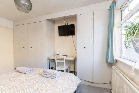 A bright and inviting double bedroom featuring ...