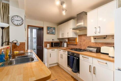 A bright and tidy kitchenette with modern appli...