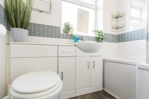 A bright and clean bathroom featuring modern fi...
