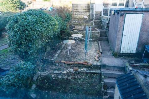 A spacious garden area with two tables, perfect...