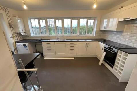 A bright and spacious kitchen with modern fitti...