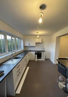 A modern and spacious kitchen with ample natura...
