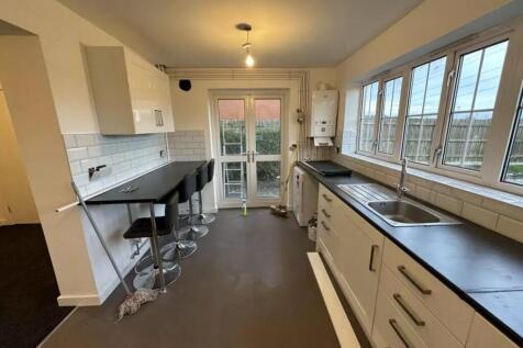A bright and functional kitchen with ample coun...
