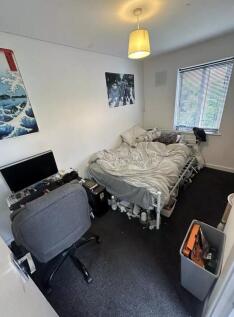 A cozy double bedroom with a comfortable bed an...