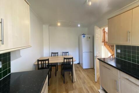 A spacious and bright kitchen area with modern ...
