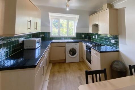 A spacious and well-lit kitchenette featuring m...