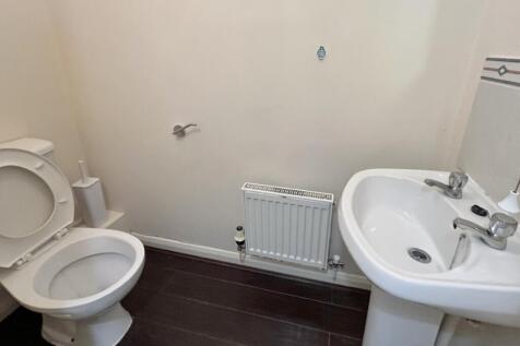 A tidy and functional bathroom featuring essent...