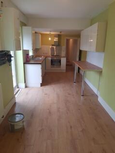 A spacious and well-lit kitchen with modern fix...