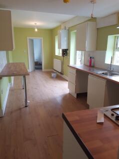 A spacious and well-lit kitchen featuring moder...