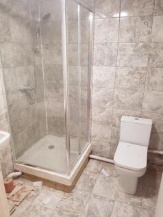A functional bathroom featuring a modern shower...