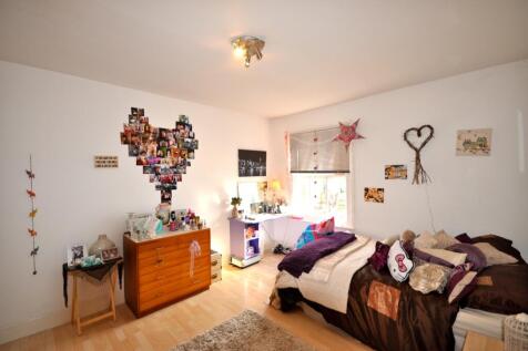A bright and inviting double bedroom with a coz...
