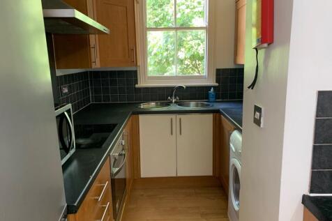A bright and tidy kitchenette with modern appli...
