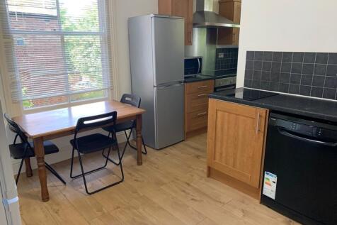 A bright and inviting kitchenette with modern a...