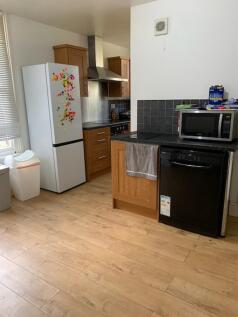A bright and tidy kitchenette with modern appli...