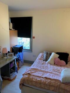 A cozy double bedroom featuring ample natural l...