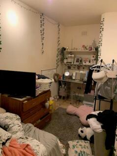 A cozy double bedroom with personal touches, pe...