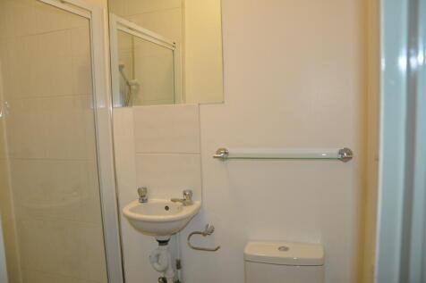 A tidy and functional bathroom with a shower, p...