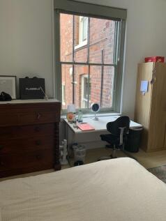 A bright and inviting double bedroom featuring ...