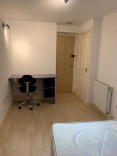 A spacious double bedroom featuring a study des...