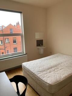A neat and bright single bedroom featuring a la...