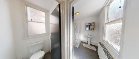 A bright and tidy bathroom featuring modern fix...