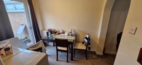 A cozy dining area with a table and chairs, per...