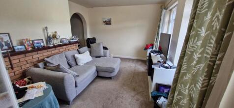 A cozy living room with ample seating and a war...