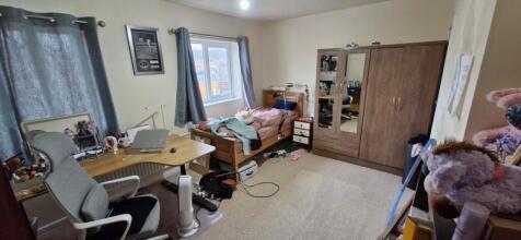 A cozy double bedroom with a comfortable bed an...