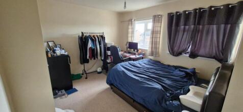 A spacious and well-lit double bedroom featurin...