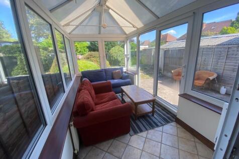 A bright and inviting large modern living room ...