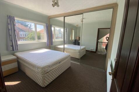 A spacious and well-lit double bedroom featurin...