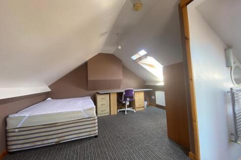 A spacious double bedroom with good natural lig...