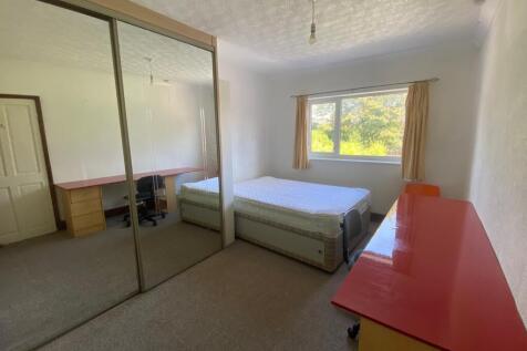 A bright and spacious double bedroom featuring ...