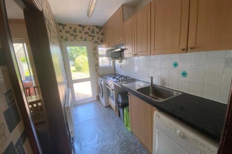 A bright and tidy kitchenette with modern appli...